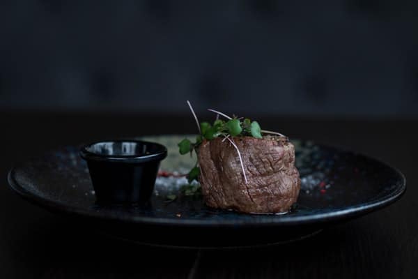 Beef steak on a black plate