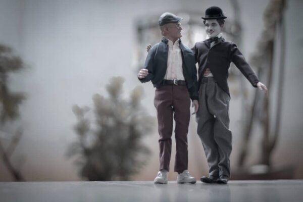 Photo of Stan Lee and Chaplin figurines